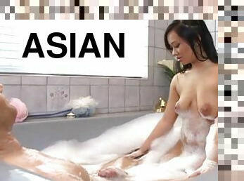 Smooth looking Asian hottie giving a handjob to a white guy