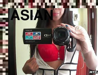 Sexy brunette Asian babe fools around with the camera