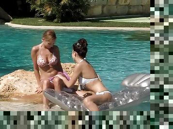 Lustful girls please each other on the lawn near the pool