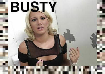 Busty blonde demonstrates her cleavage in backstage tape