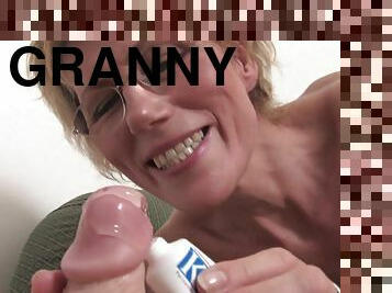 Granny pussy stretches around a dildo as she fucks it