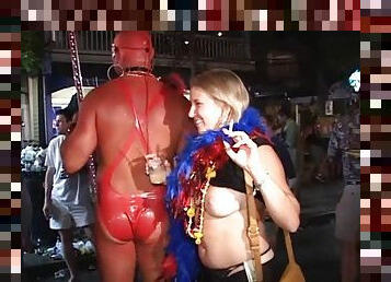 Randy lesbians in mardi gras party kissing in public