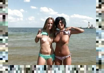 Two petite beauties showing off their arousing bodies on the beach