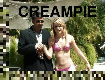 Chick in a shiny bikini takes a creampie from his big cock