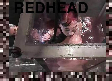Redhead slut gets suspended and immersed in the water