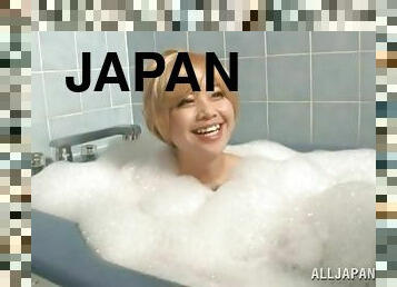 Blonde Japanese girl takes a bath and sucks a dick