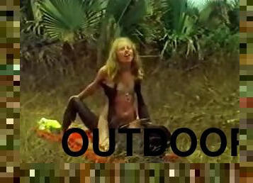 Blonde hottie takes a ride on a BBC outdoors. Hot vintage clip