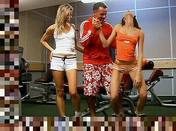 Lewd trainer fucks two horny babes at the gym till orgasm