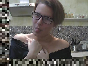 Solo girl with glasses chatting in the kitchen