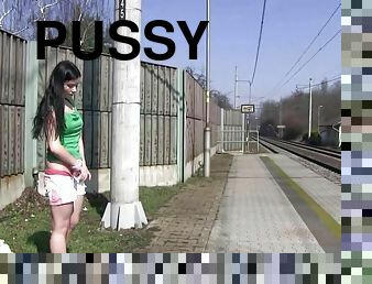 Cute brunette filly fingers her pussy at the train station