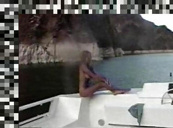 Big breasted celebrity shows off her body on the boat