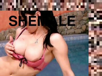 Dark-haired shemale shows off her pointy dick inside the pool