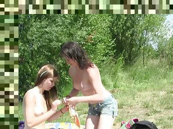 Sunbathing beauties slip off their bikinis and eat pussy lakeside