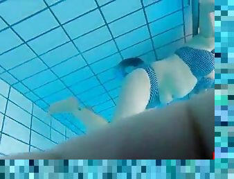 Girsl underwater at pool