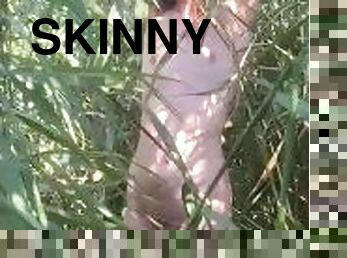 Skinny naked twink in the reeds showing his cock