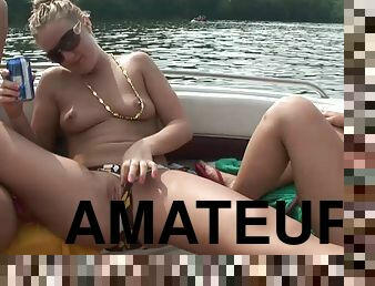 Two salacious amateur chicks flash their tits in a boat