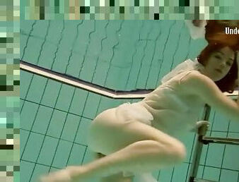 Flawless teen in sheer white lingerie swims