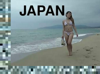 Gorgeous feminine Japanese shemale in a bikini on the beach