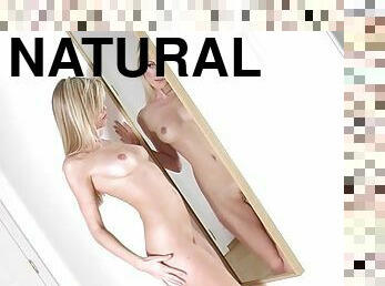 Alluring blonde poses nude in front of the mirror for sexy shots