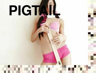 Doll face brunette gets playful with a wooden ruler