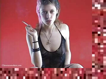 Rocker babe in see through outfit has a smoke whilst teasing us