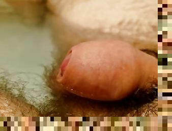Close up of tiny dick pulsing while relaxing in water while tacking bath