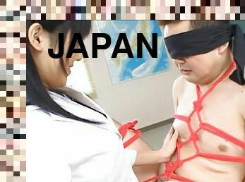 Long haired Japanese hottie jerks off her stud in a kinky bondage fetish shoot