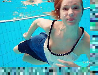 Skinny Russian bint dives into the pool completely naked