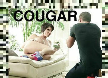 Tattooed cougar with big fake tits enjoying a hardcore cowgirl style fuck
