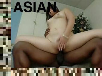 Asian with a sexy shaved pussy sits on a dick