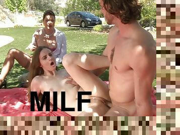 Milf masturbates in the grass as a cute chick gets fucked