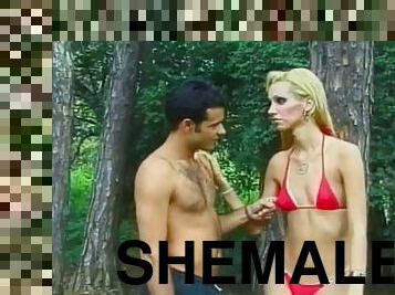 Cute young blonde shemale Giselle Davila with perky tits loves getting her ass fucked in the woods