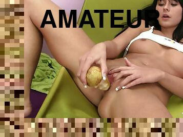 A hungry, kinky girl fucks her pussy with a potatoe