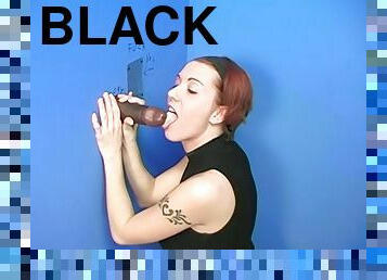 A white girl enjoys black cock at a naughty gloryhole