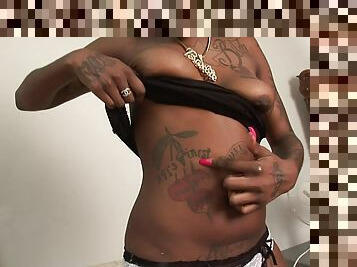 Dazzling tattooed ebony with natural tits showcasing her black butt backstage