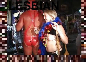 Randy lesbians in mardi gras party kissing in public