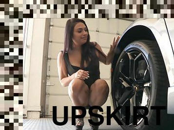 She flashes an upskirt while crawling around in a car