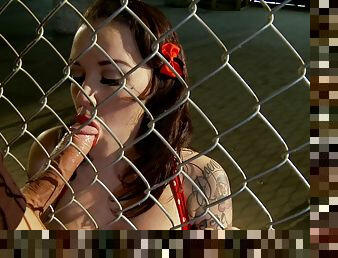 A guy eats her ass then fucks her against a fence at a park