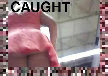 Chick wearing a miniskirt gets caught on a voyeur's cam
