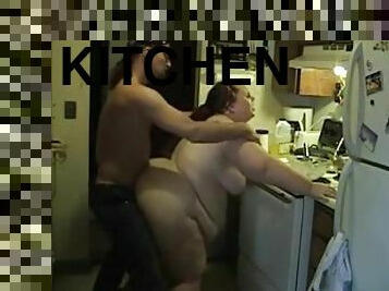 Long-haired fattie enjoys rear pounding in the kitchen in homemade vid