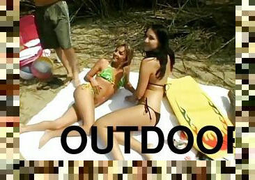 Sunbathing beach babes share a lucky guy's fat cock