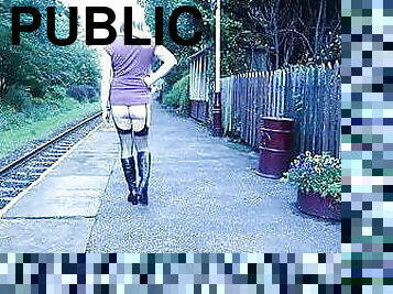 Crossdressed ooudoors on a public railway platform