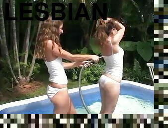 Hot babes have a lesbian moment in an inflated pool