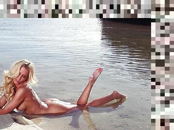 Super hot model is posing naked by the lake