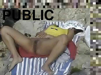 Spy cam video with a girl in a nude public beach in Mallorca