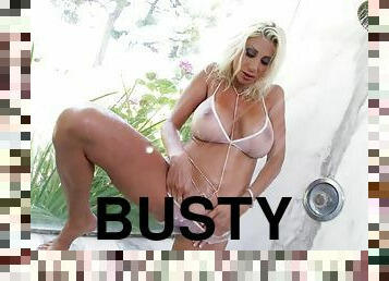 Busty blonde Puma Swede plays with a dildo in the bathroom