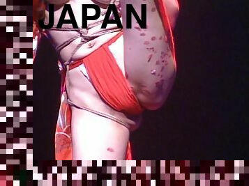 Marvelous Japanese chick in bondage entertains a crowd of people in this live on stage scene