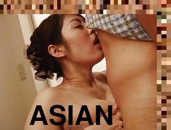 Asian milf slides a throbbing pecker between her bib melons