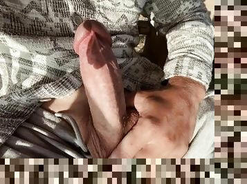 The guy masturbates a huge beautiful dick in nature at dawn on a day off