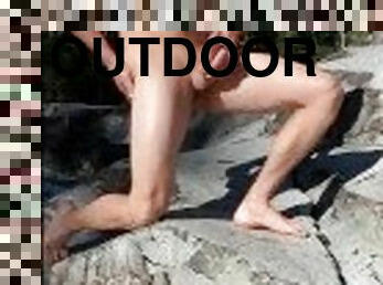 Hot guy getting naked by waterfall